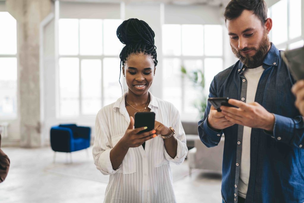 Two colleagues picking up a customer conversation on a phone