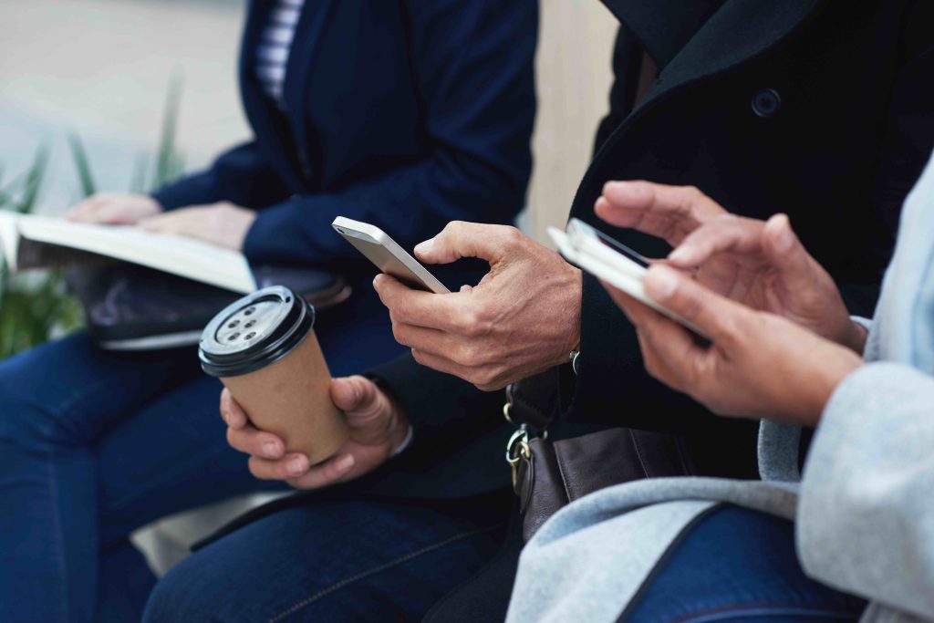 Members checking their phones between visits