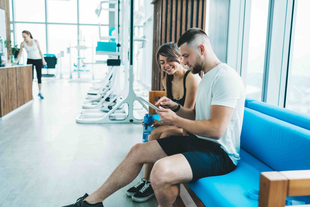 Two people looking at a phone in a leisure club
